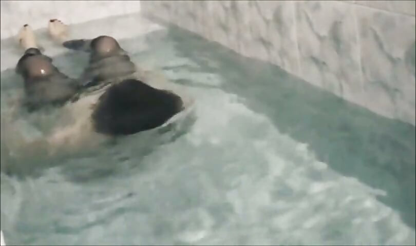 Sissy underwater attempting to perform autofellatio