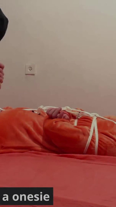 Miriam bağlı ve onesie içinde gıdıklıyor