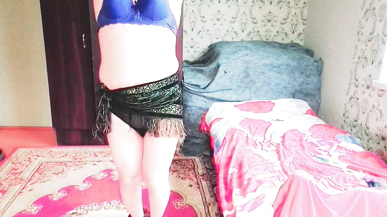 Cute femboy lifting skirt slightly under soft lights