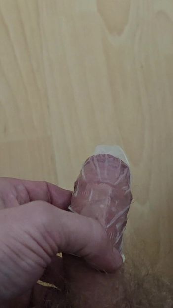 Piss in condom. I filled a condom with my pee and a lot of it ended up on the floor. Horny cock urinates in a rubber.