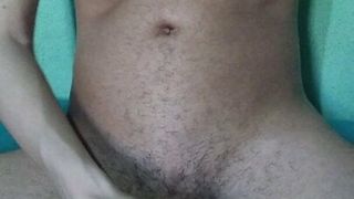 Young hairy skinny sitting on the bed masturbating