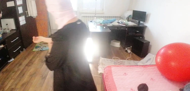 Amateur woman has fun trying on clothes and cutting them.