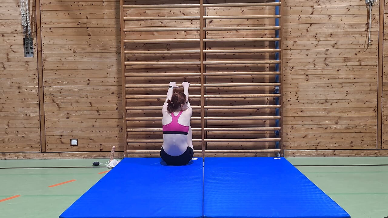 Kinky girl fucks a dildo in the school gym