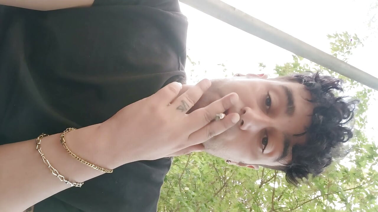 Fumando al aire libre y mostrando bolas y polla suave sin cortar