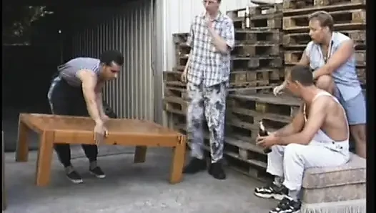 Dirty old blonde gets fucked from behind while sucking cock in gang bang