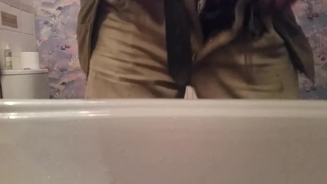 Close up pissing with a cock ring dick in the sink