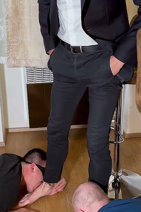 Managerial Control: Businessman Boman Steps Barefoot on Slave Ben