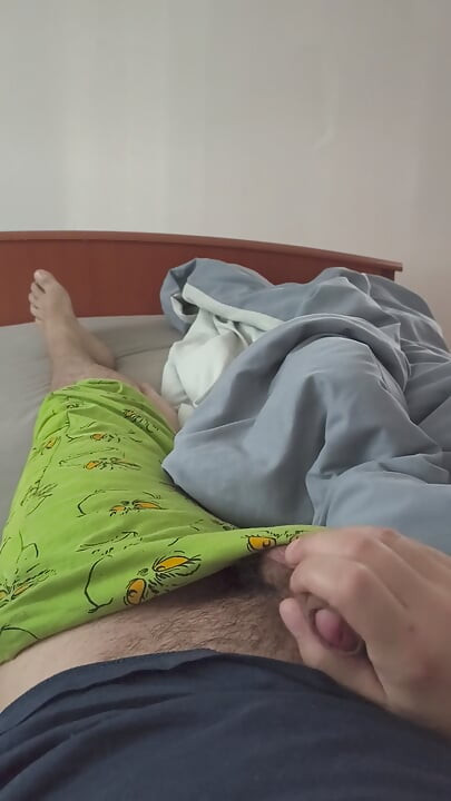 Cute handjob on the bed with a hard and erect penis