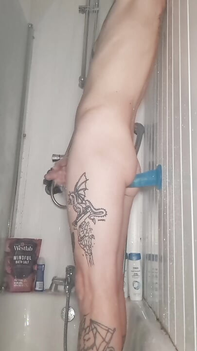 Skinny pale tattoo sissy fucks dildo in shower