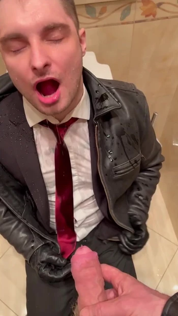 Office boy in suit takes a piss from his boss