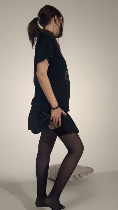 Faceless masked girl lifting black miniskirt – slow tease