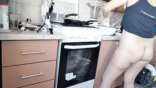 Sexy wife prepares lunch naked in the kitchen.