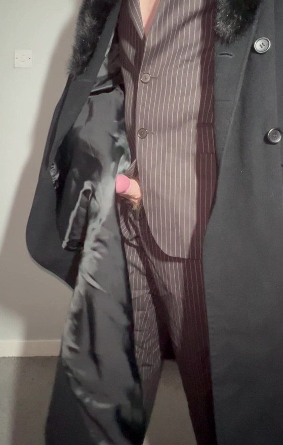 Sissy playing with cock in a ladies long coat and suit stroking myself with the lining of my coat
