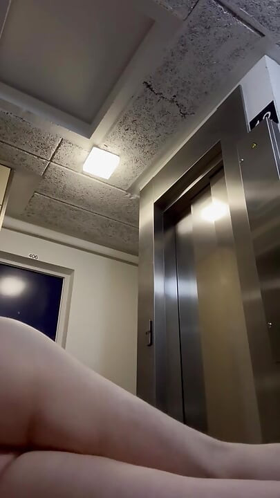 In the hall in front of the elevator