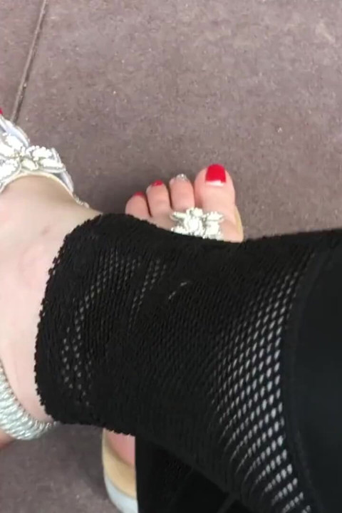 Sandals teasing outdoor with red toenails & toes wiggling