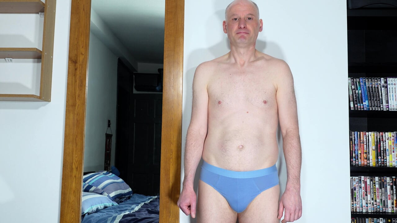 Zoom in close up as man takes off underwear and wanks his uncut cock from soft to throbbing erection