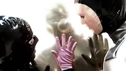 Two masked chicks are having fun with their slave