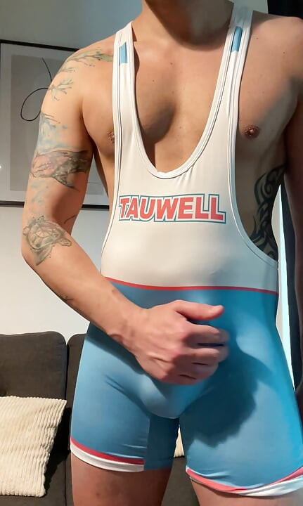 Smooth jock in wrestling singlet jerks off and cums