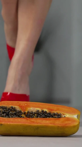 Emotional moment from "Petite girl crushes fruits with high heels! Hot footfetish!"