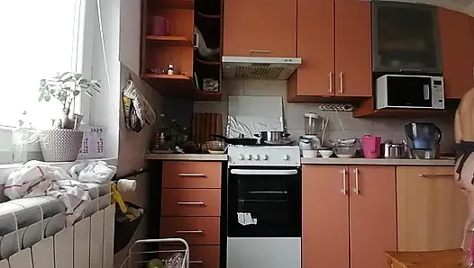 Sexy brunette doing naked chores around the house.