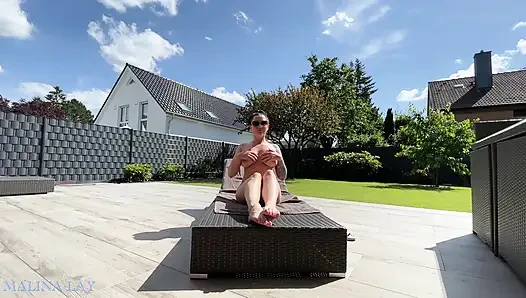 Hot milf pampers her sexy body on the terrace and oils herself