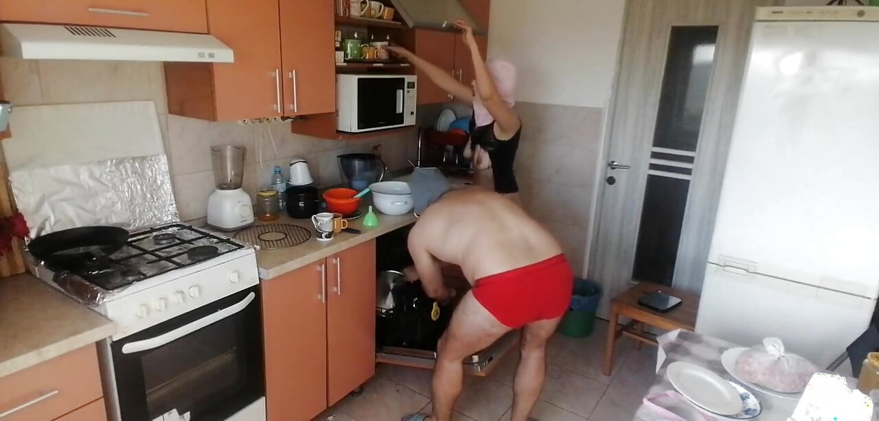 Couple Having Fun in the Kitchen. Sexy Wife Doing Chores in the House Naked