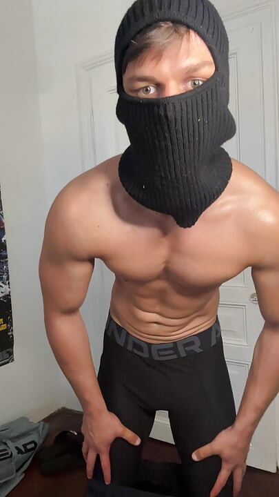 Masked hunk showing off his muscles