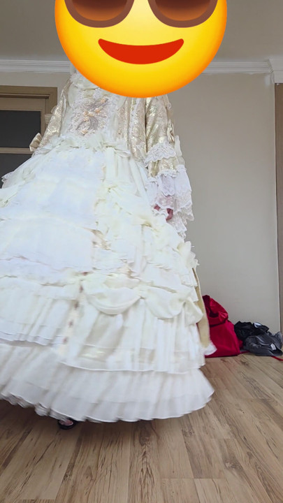 A crossdresser dancing in a dress.