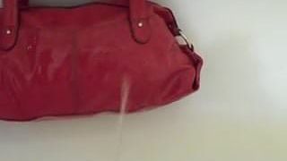 Pee on red handbag