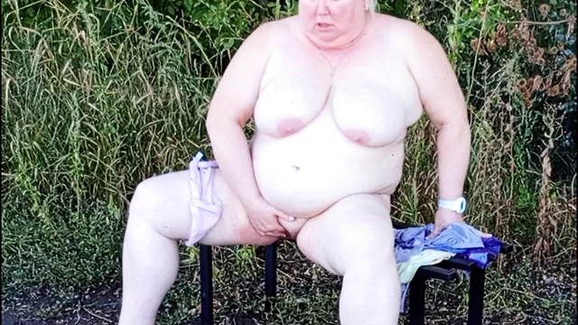 Stepmom in the park undressing and masturbating on a bench