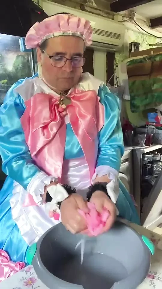 In a blue maid's outfit with pink bows to do the laundry.