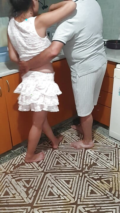 A Turkish couple flirting in the kitchen.