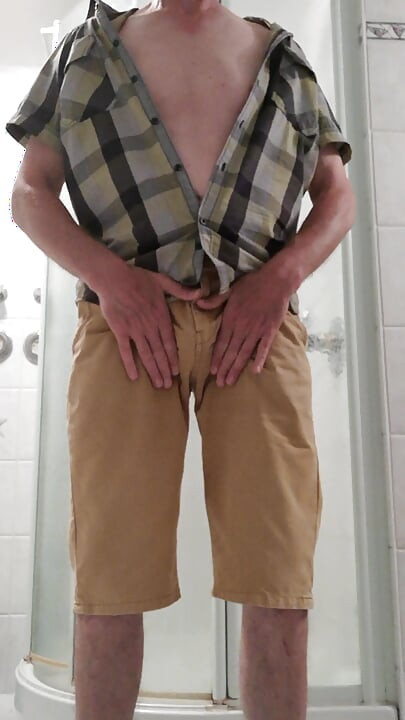 Strip in the bathroom with cockring around the balls and cumshot on the living room couch