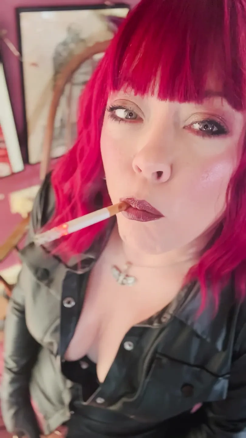 Your Mistress Tina Snua dressed In Leather Chain Smoking 2 Cork Cigarettes