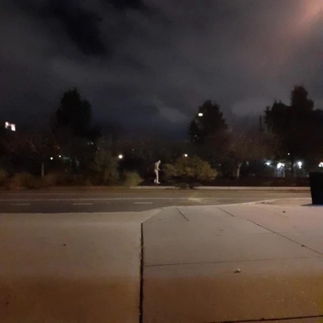 Streaking a street at night under a full moon