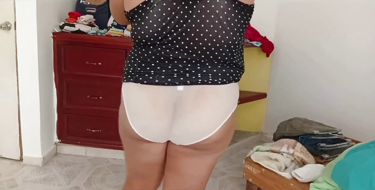 Mollig meisje dat de kamer opruimt en kleren vouwt