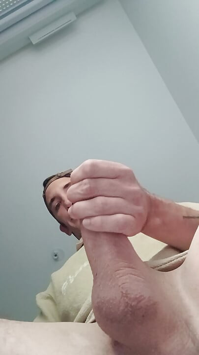 Young guy jerks off his big cock and cums