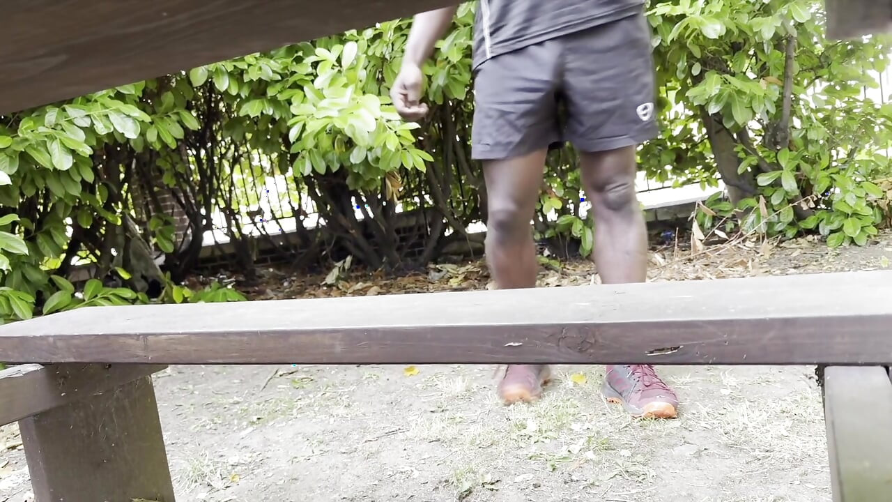 Sedí na lavičce v mých šortkách a pracuje s Výhledem mezi nohama