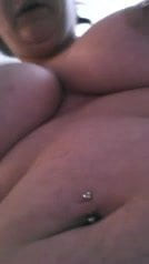 Chubby playing with a dildo on her pierced pussy