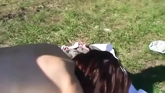 Brunette MILF with glasses loves sucking cock on her knees out in the fields