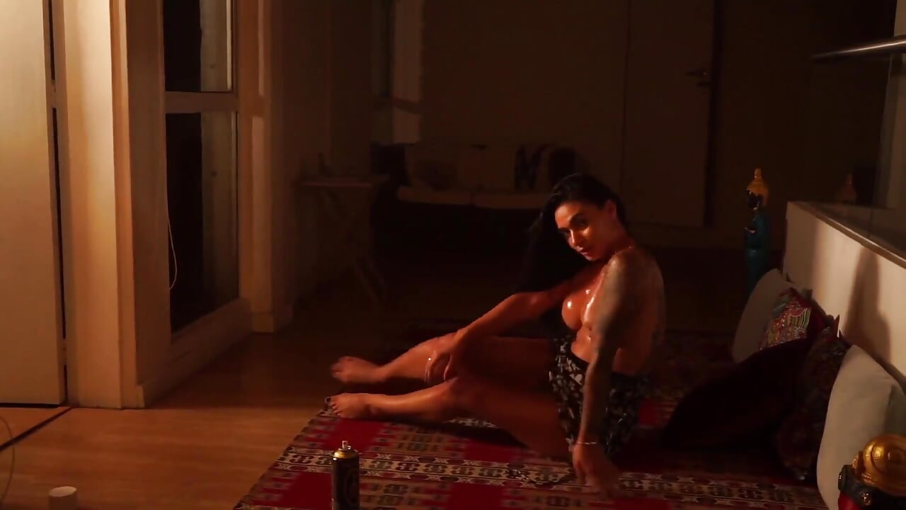 Sensual Latina Doing a Striptease in Low Light