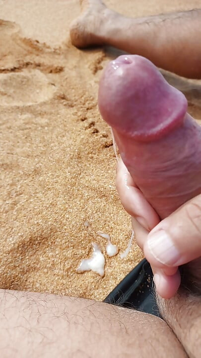 Ladysilva jerking off his big hot cock until he grasps on the deserted beach