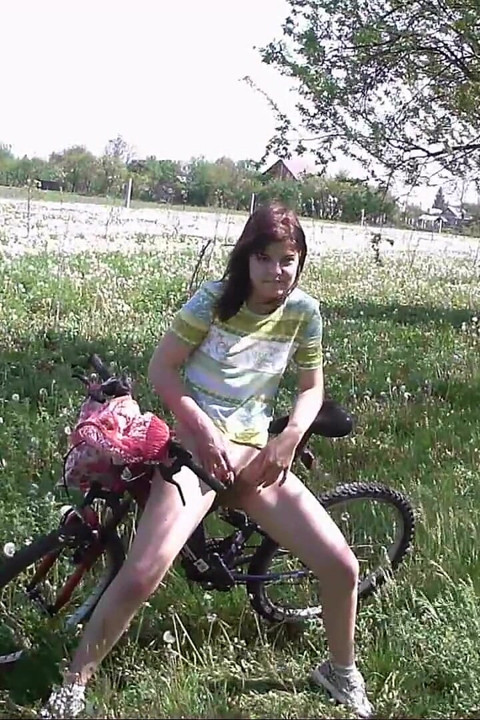 Peeing on her bicycle
