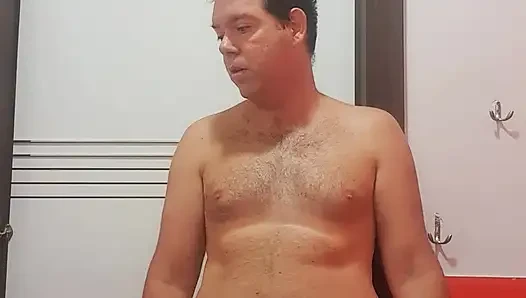 A boy completely naked in a station bathroom