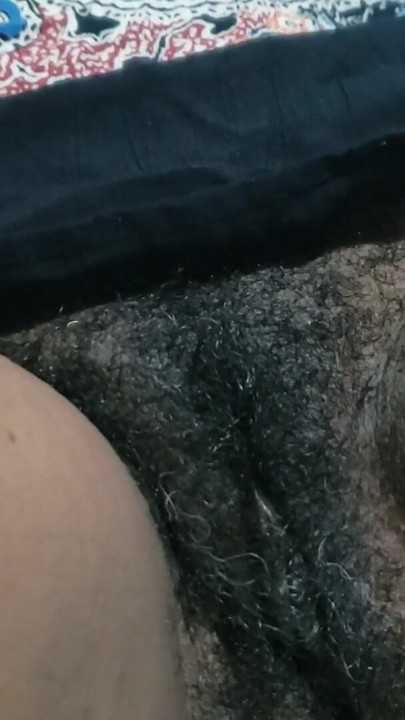Seductress show you her hairy pussy side of mature in a dimly lit room filled with sultry shadows | Clip 1