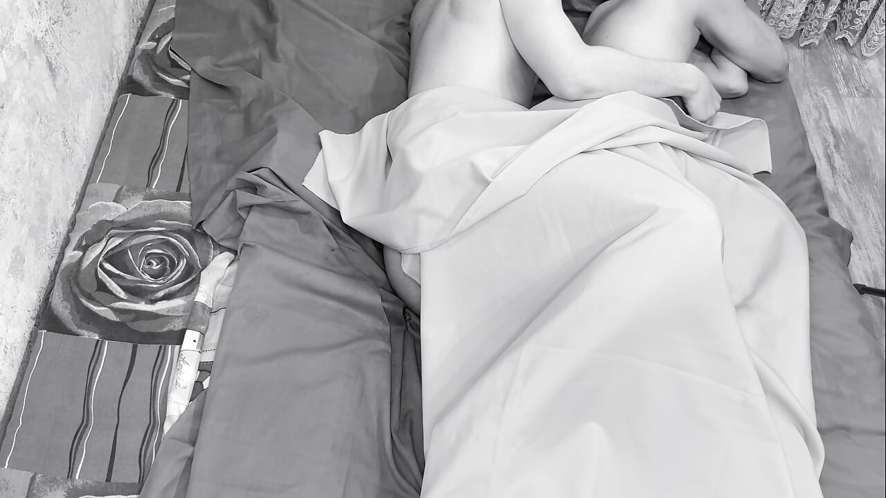 Couple caught on camera having sex in bed .