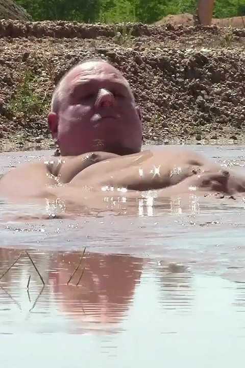 Deep, Creamy Brown Mud Bath in a Sand Pit