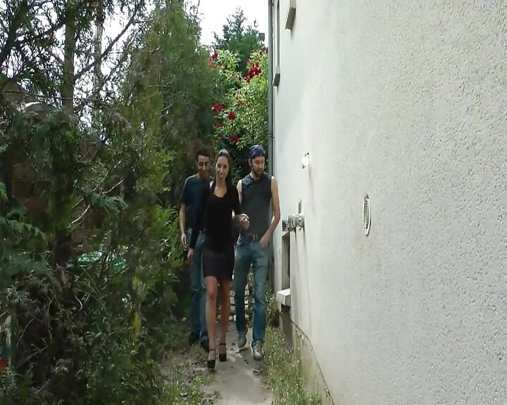 A Pretty Brunette Is Being Fucked by Three Big Cocks in the Garden.