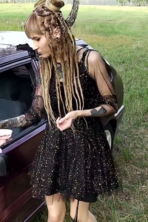Rebellious Girl with Tattoos and Dreadlocks Fucks with a Dildo Next to the Car