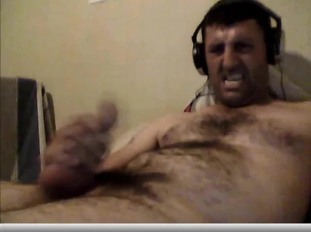 evil face jerking off his cock and cums on his stomach